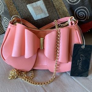 CROSSI NY. NWT. Beautiful Coral, crossbody bag with bow on front. Gold c…